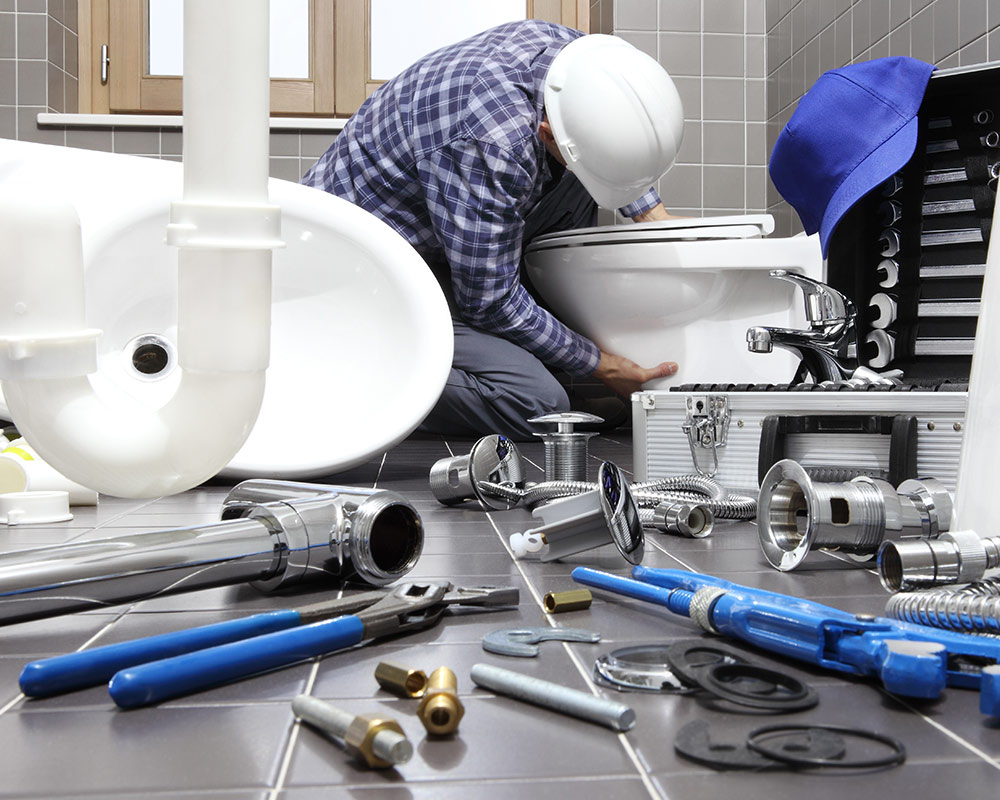 plumber replacing bathroom toilet and tools laying at the floor glenmora la